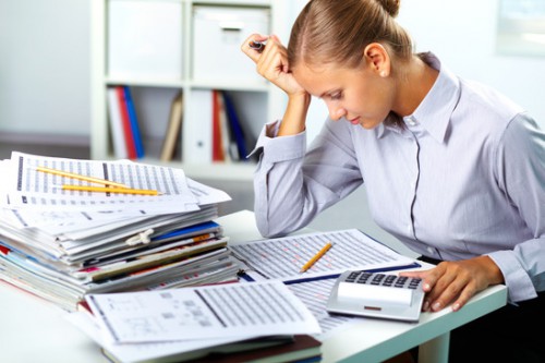 Portrait of a young businesswoman working with papers in office