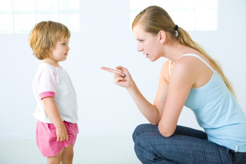 Mother disciplining toddler daughter